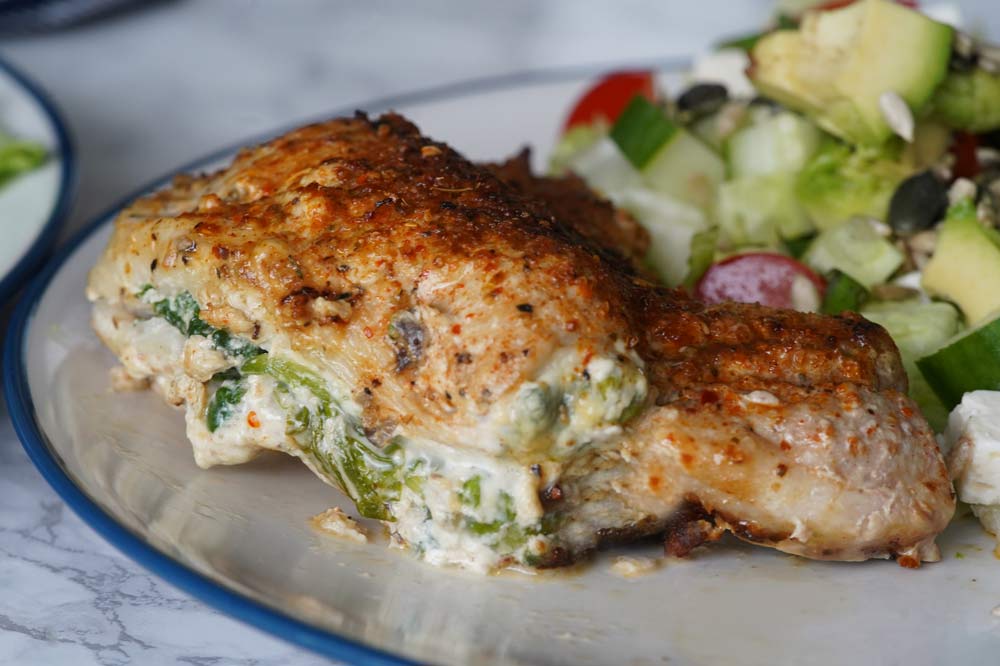 Cooked stuffed pork chop on a plate with salad