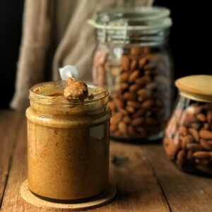 A jar of almond butter and jars of almonds