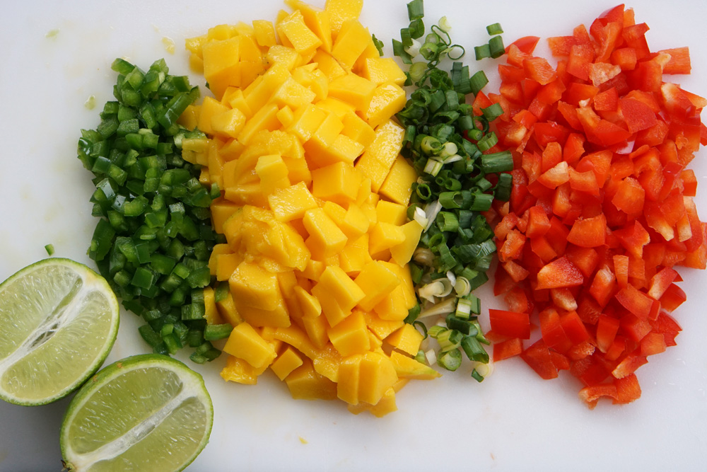 Chopped jalapeno, mango, green onion, and red pepper with a lime