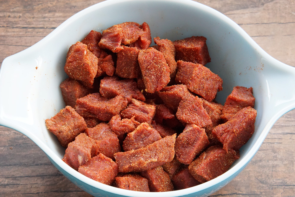 uncooked steak bites coated in Cajun seasoning