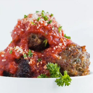 A bowl of meatballs and tomato sauce