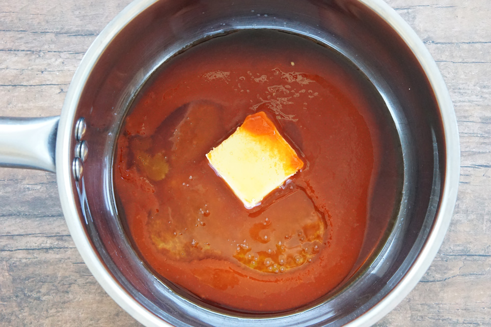 all of the ingredients for honey sriracha sauce in a saucepan
