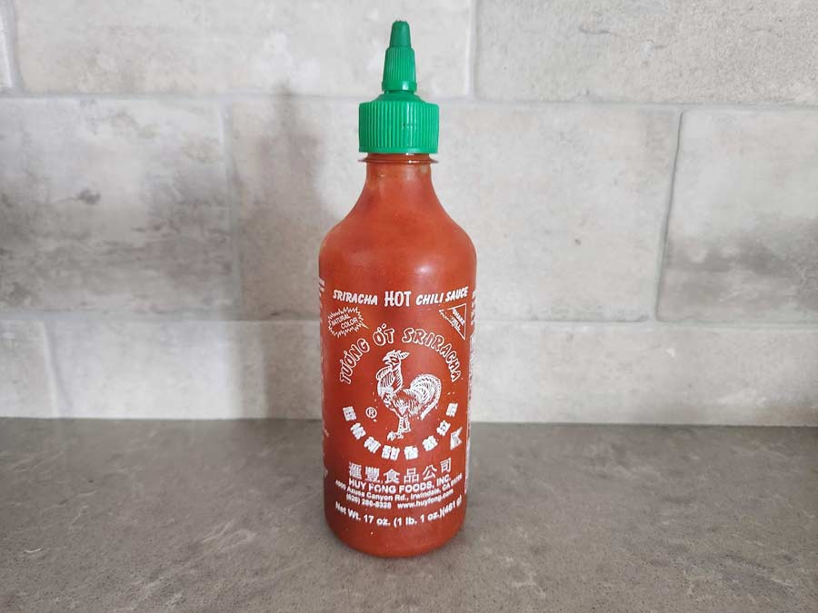 A bottle of Sriracha sauce