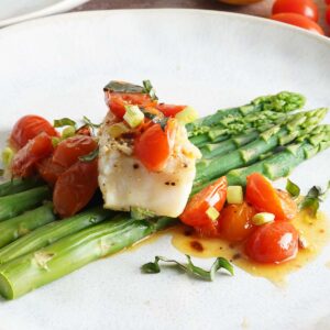 Cod with asparagus in a tomato lemon butter sauce