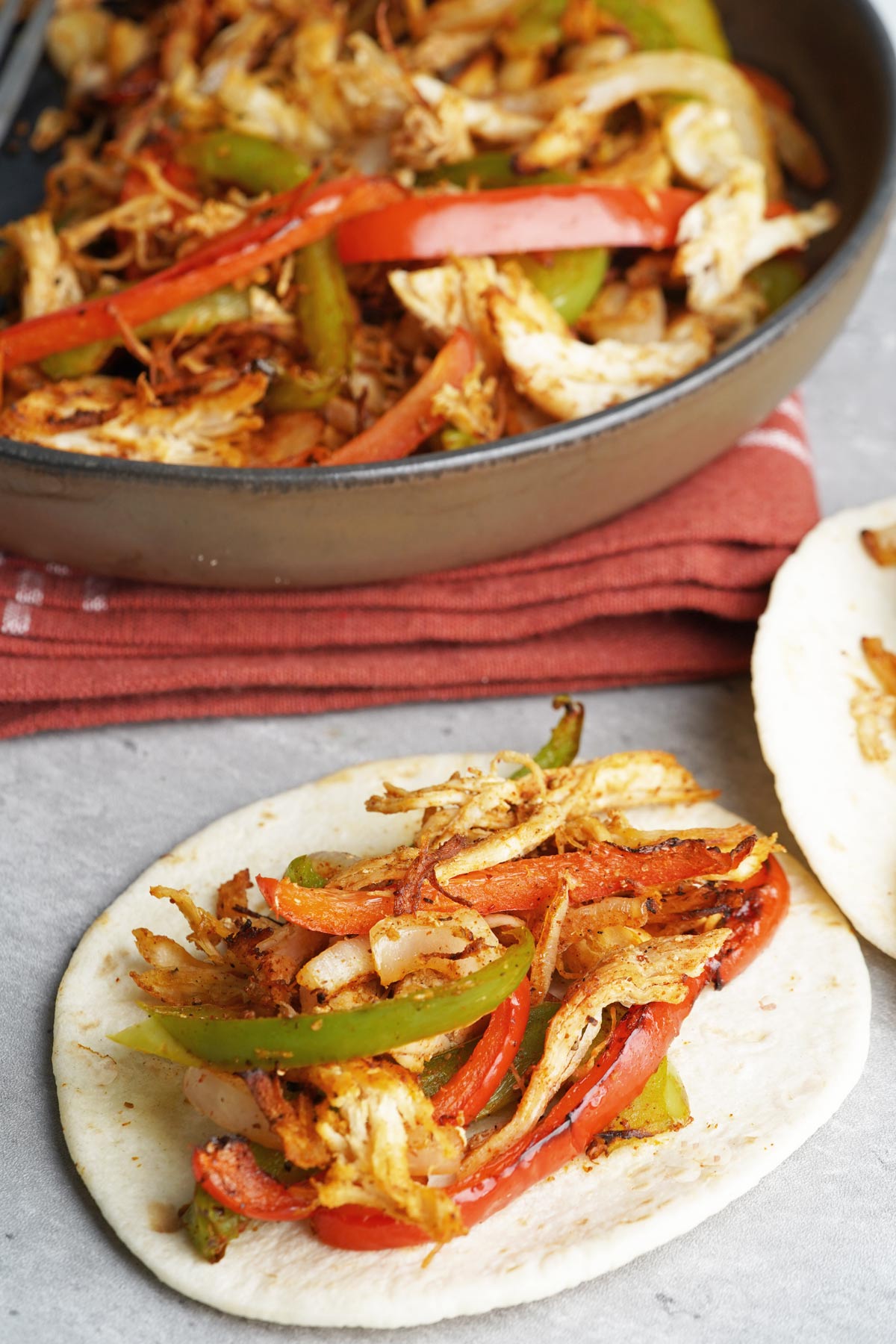 shredded chicken fajitas on a tortilla
