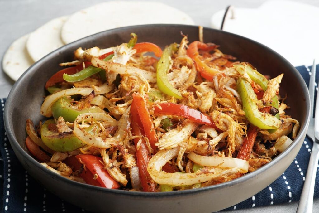 shredded chicken fajitas in a serving dish
